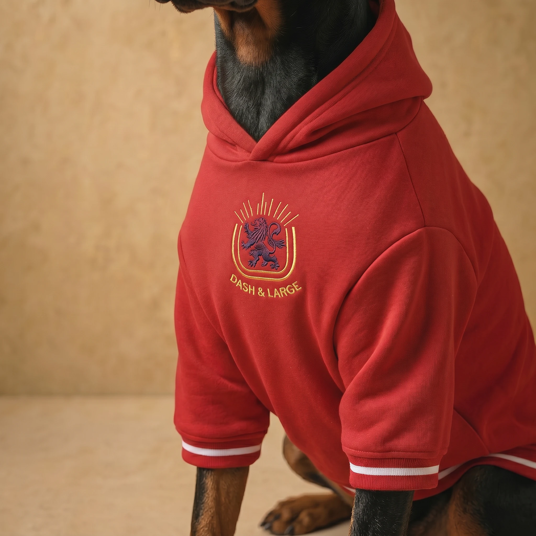 Doberman in NookPaws™ Heritage Red Deep-Chest Hoodie, showcasing soft heavyweight fleece texture and gold embroidery, designed for large-breed comfort and calm, minimalist style.