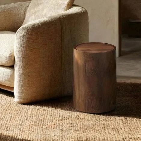 Cylindrical wood-grain waste bin with concealed liner sits beside a textured armchair on a woven rug, blending seamlessly into a calm, minimalist interior with harmonious pet living in mind.