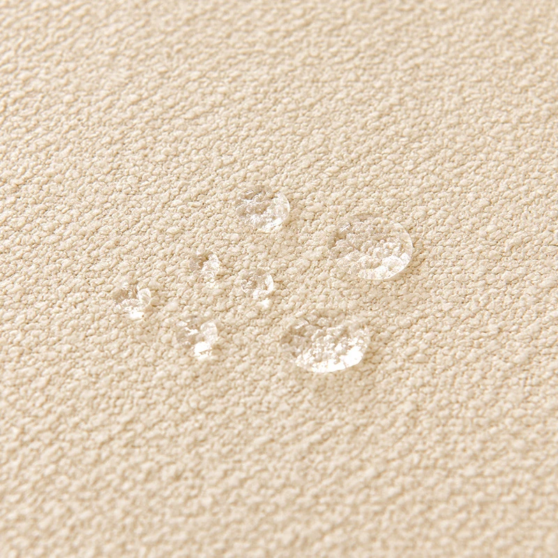 Soft beige Teddy velvet fabric with water droplets beading on surface, showcasing scratch resistant fabric durability in a calm, pet-friendly home setting.