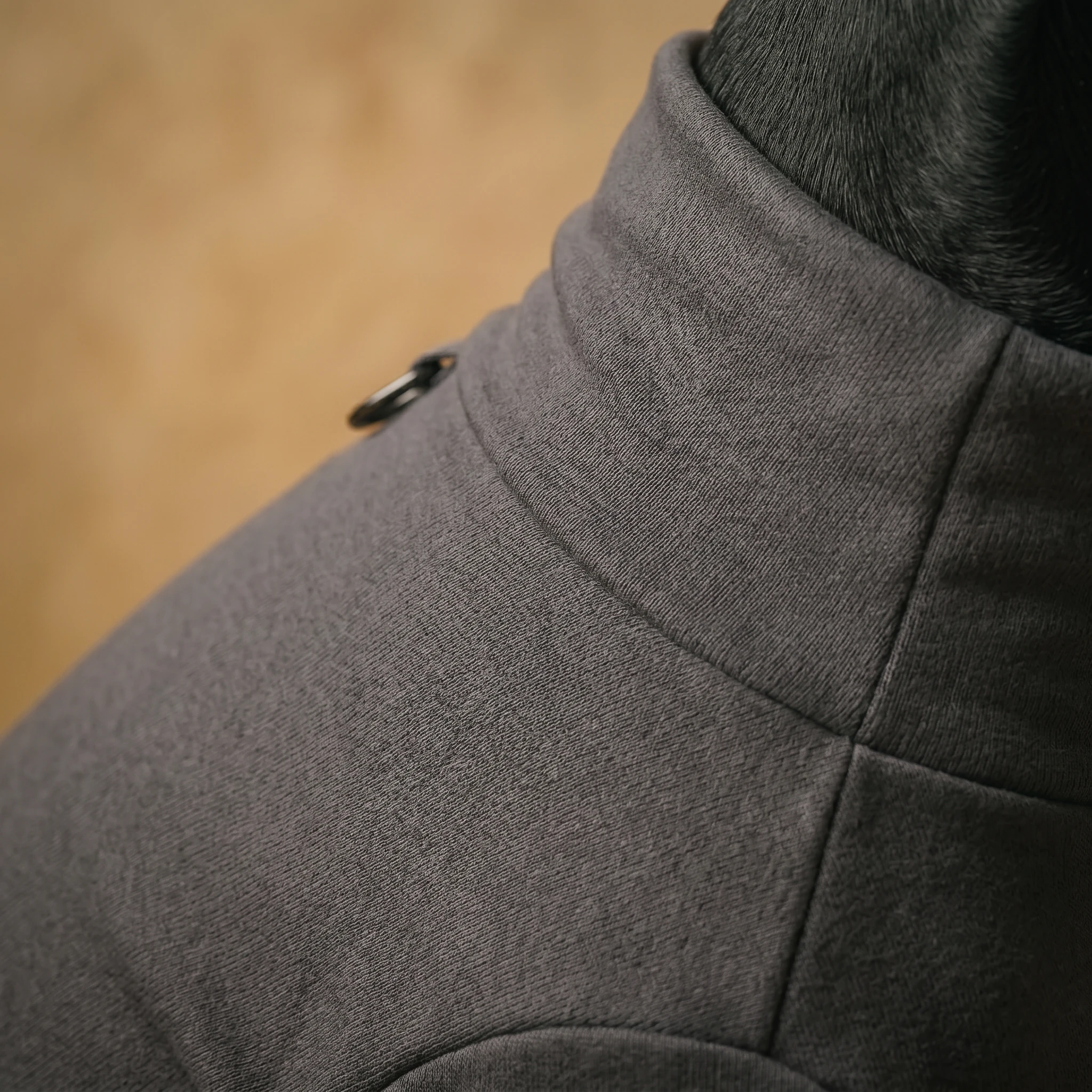 Close-up of NookPaws™ Doberman Recovery Suit in heather gray, showcasing soft ribbed fabric and tailored neck fit on a deep-chested dog, with warm ambient lighting highlighting minimalist design.